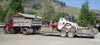 Delivery truck and trailer with bobcat excavator